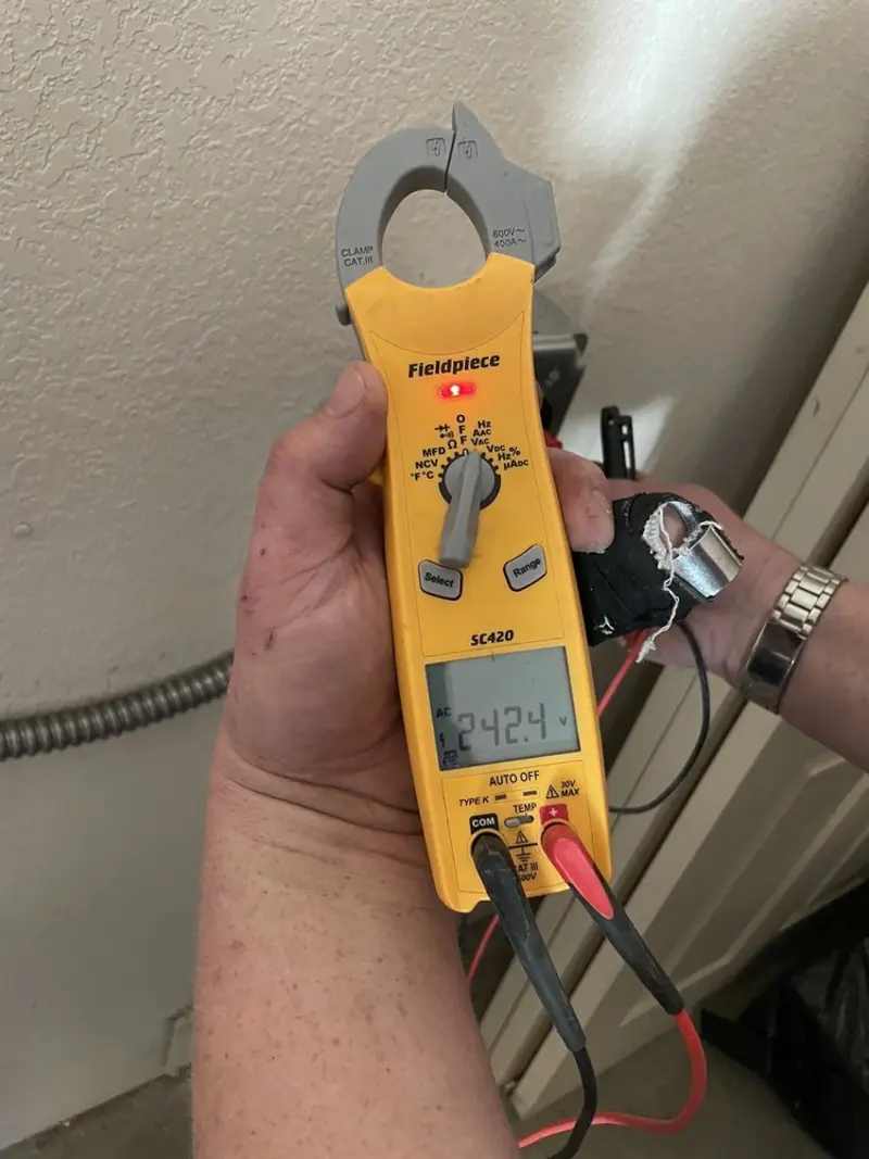 Voltage testing with clamp meter during Electrical Installation Services in Highland
